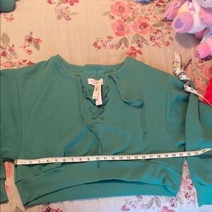 Green cropped sweatshirt with criss cross detail from Victoria’s Secret